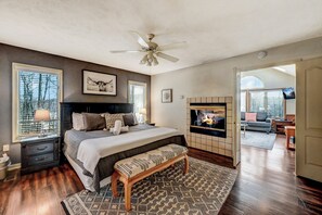 Bedroom on the main floor with king size bed, fire place and en suite bathroom