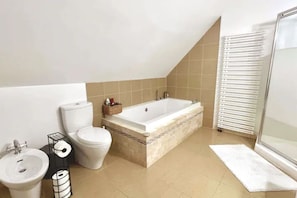 Roomy bathroom with lavish tub and bidet included if you’re feeling zesty