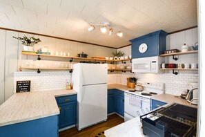 Open Kitchen with all the supplies needed for a home-cooked meal! We have coffee , tea, creamer, condiments, spices, pots, pans, plenty of dishes and utensils! We have everything you need!