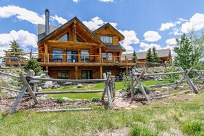 Wrap around deck with hot tub looks out over the Madison River