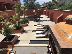 View from patio of pool and hot tub area
