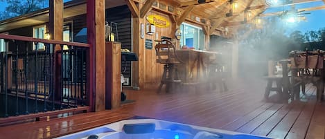 At the edge of the deck, the hot tub!