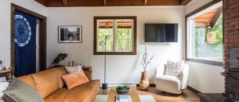 Living room area with wood burning fireplace. Photo: Shelter Upstate