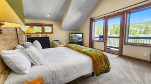The beautiful master suite features vaulted ceilings, impressive views, and access to the outside deck area.