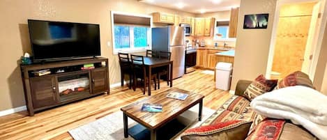 Living Room with Smart TV looking into Full Kitchen