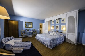 View of the 1st bedroom with a king-size bed and a luxurious blue theme. with AC