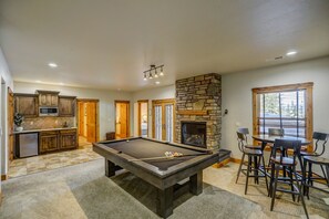 Enjoy a game of pool in the daylight basement--complete with a gas fireplace and wet bar