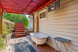 Immerse in nature with an outdoor shower and antique soaking tub