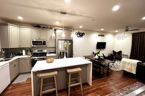 Kitchen with Dining table and living room.