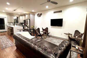 Living room with Dining table behind.