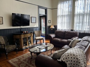 Amy's Schoolhouse living room filled with natural light from the large schoolhouse windows.