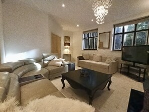 Bright modern living room area with television unit. 