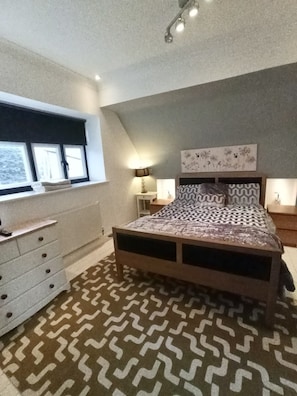 Large bright bedroom with ensuite bathroom and clothing storage.