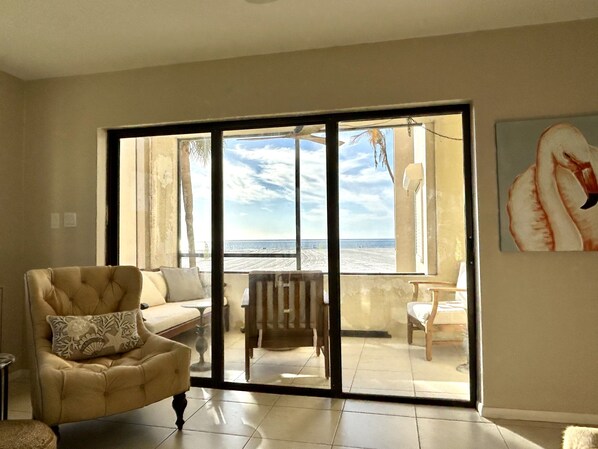 Gulf front, screened in lanai with comfy furniture and ceiling fan. Direct view.