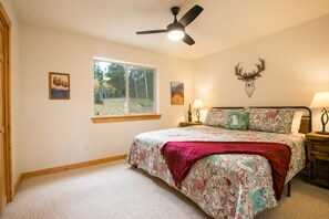 The lower floor king bedroom has great forest views and a large closet for you to unpack