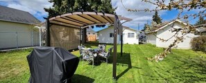 Our covered seating area and BBQ in the fully fenced back yard