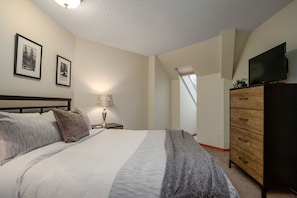 Spacious bedroom with queen bed & TV