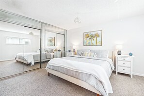 Cozy master bedroom with a plush king bed and plenty of natural light