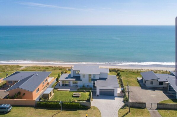 Aerial view of property right on the beach front