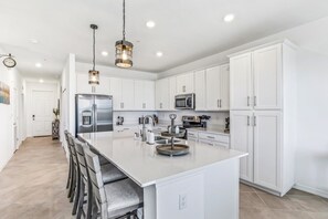 Entryway into the Fully Stocked Kitchen