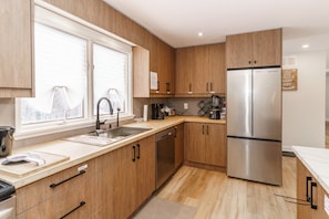 The kitchen is modern, inviting and fully-stocked