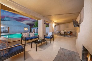 Plenty of seating near the outdoor fireplace and smart TV