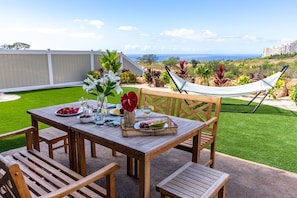 Al fresco dining on the patio as you look toward the water.