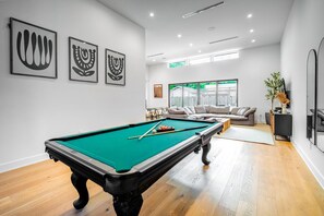 Enjoy competitive fun with your group at the entrance pool table.