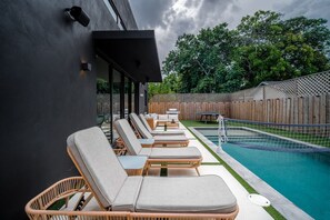 A backyard pool with brand new sun beds, perfect for soaking up the Miami sun.
