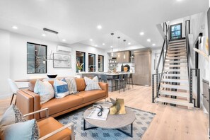 The main living room area on the second level of the home features an open-concept layout, seamlessly connecting with the kitchen and dining area.