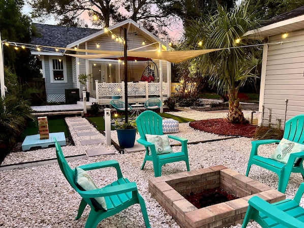 Backyard entertainment area. Fire pit, shade sails and seating