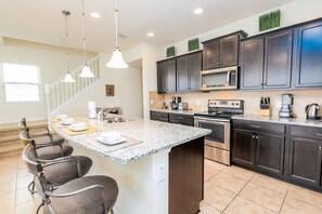 A fully-equipped kitchen with stainless steel appliances and granite countertops