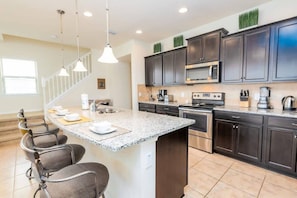 A fully-equipped kitchen with stainless steel appliances and granite countertops