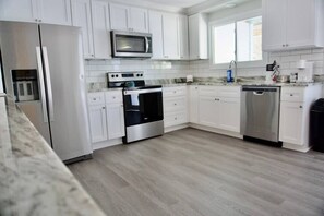 Beautiful open kitchen with new stainless-steel appliances