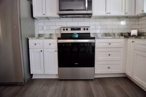 Beautiful open kitchen with new stainless-steel appliances