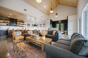Living Room: Inviting and stylish space with high ceilings, perfect for gathering and relaxing!m