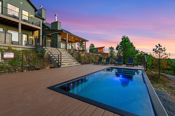 Outdoor Oasis: Dive into relaxation by the heated pool with stunning sunset views!