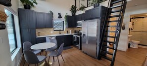 Kitchen with full size appliances & seating for four.