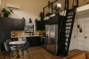 Kitchen with full size appliances & seating for four.