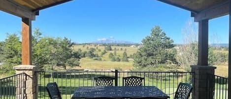 Looking out onto the deck from the breakfast room to Pikes Peak.