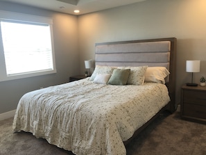 Primary Bedroom with King Size Bed, Smart t.v., attached bathroom and closet