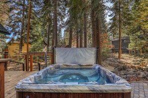 Relax and unwind in the hot tub while taking in the peaceful setting of the private backyard.