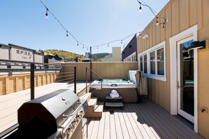 Upper level deck with a private hot tub and BBQ