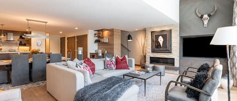 Contemporary furnishings surround a Smart TV and cozy gas fireplace