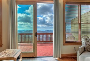 The deck's easy access from the living room allows you to seamlessly transition between indoor comfort and outdoor beauty.