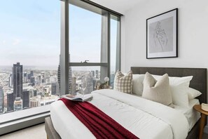 The master bedroom with a queen sized bed & a view.