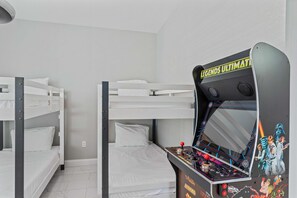 Discover endless fun in Bedroom 3, equipped with two single size bunk beds and an arcade game, creating a playful retreat for kids and adults alike.