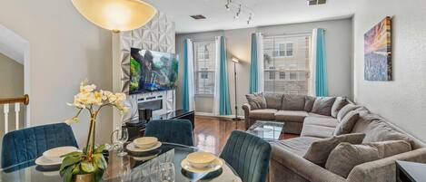 Living room with indoor fire place, smart TV and dining area