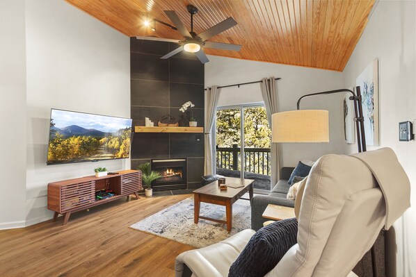 Cozy Fireplace Gathering -
Snuggle up by the grand gas fireplace in our inviting living area, complete with a large Smart TV for your entertainment pleasure. 