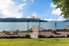 Bistro lights add ambiance to fire pit and private dock area.